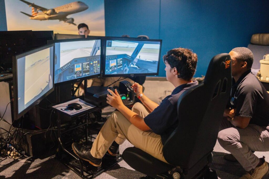 STEM Student Flying a Simulator